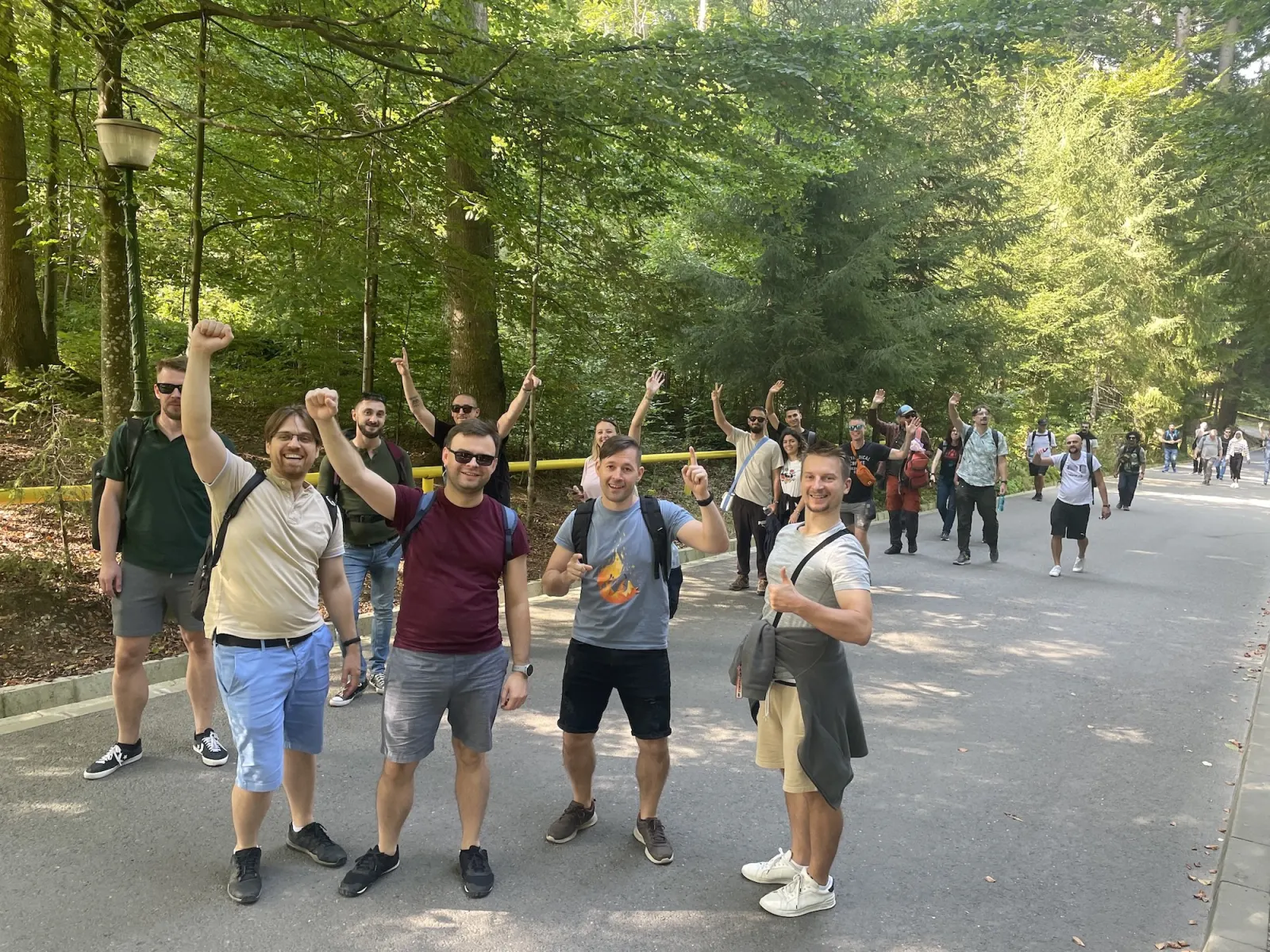 Attendees cheering on a forest road during the Friday mountain trip