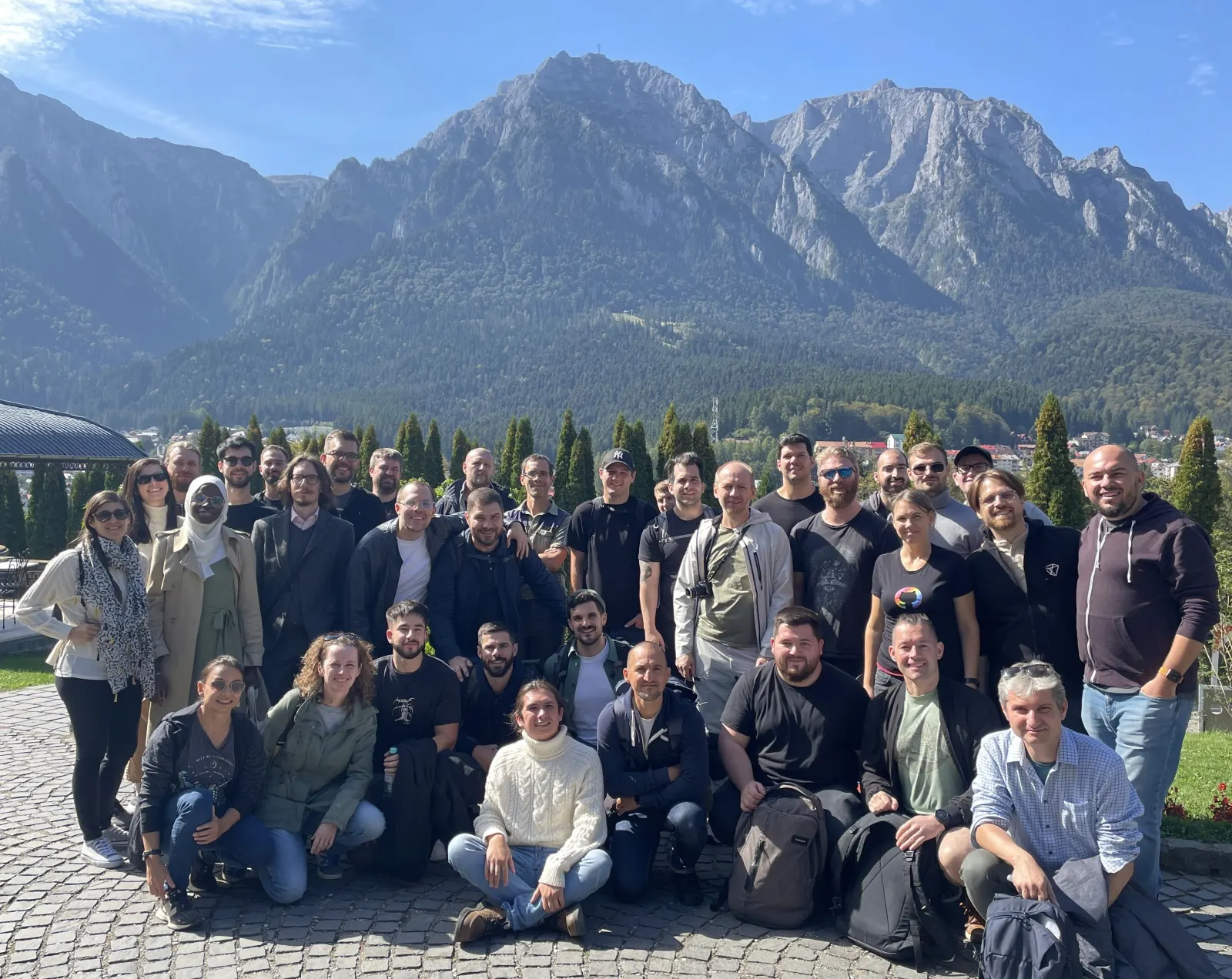 Friendly.rb attendees posing as a group in front of the Bucegi mountains